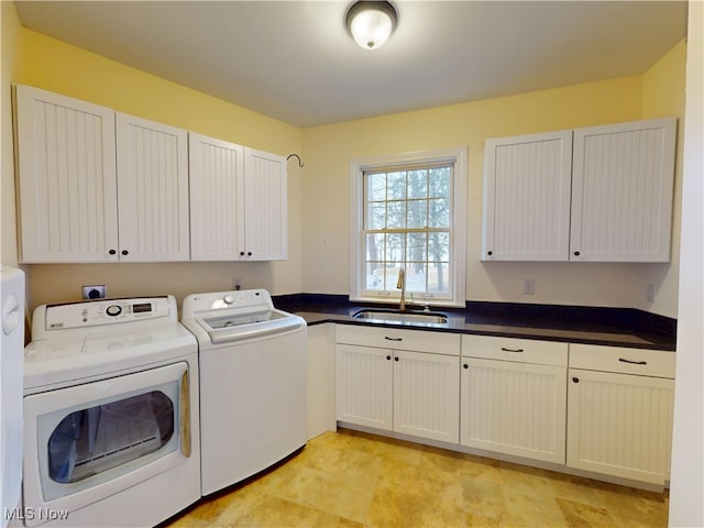 laundry room featuring cabinet space, a sink, and washing machine and clothes dryer