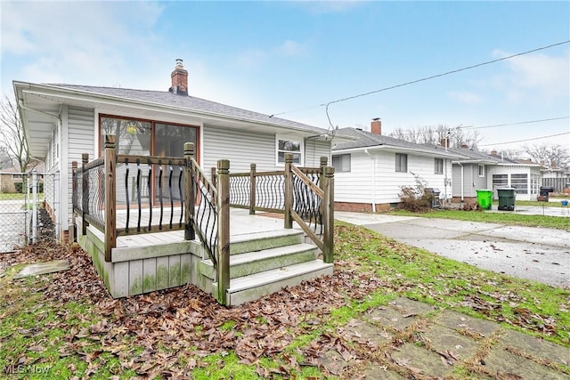 exterior space with a chimney and a wooden deck