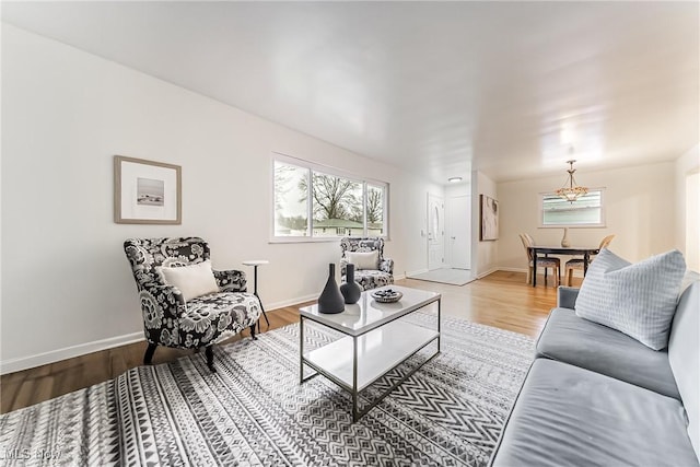 living area with baseboards and wood finished floors