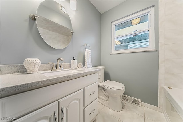 bathroom with visible vents, toilet, vanity, baseboards, and tile patterned floors