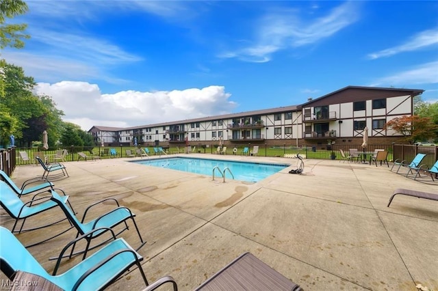 pool featuring a patio area and fence