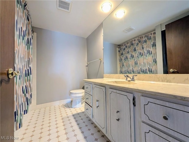 bathroom featuring baseboards, visible vents, toilet, a shower with curtain, and vanity