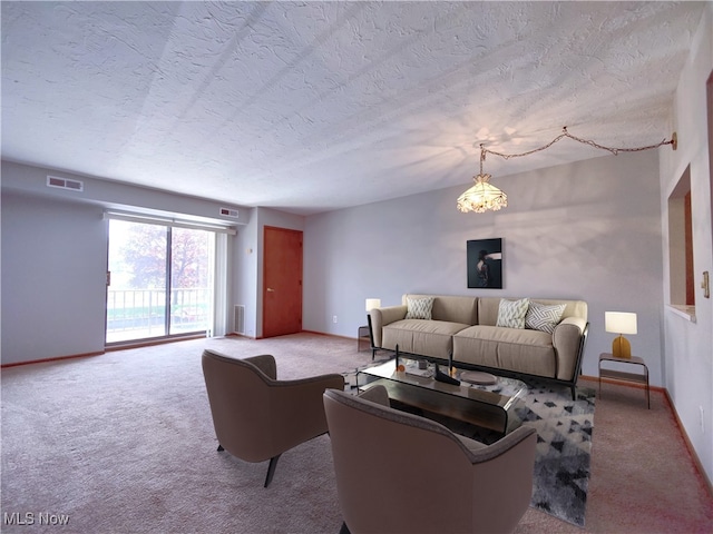 carpeted living area featuring visible vents, a textured ceiling, and baseboards