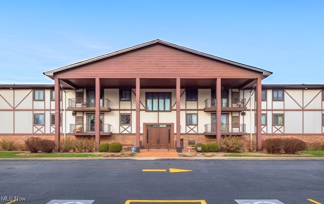 view of building exterior with uncovered parking