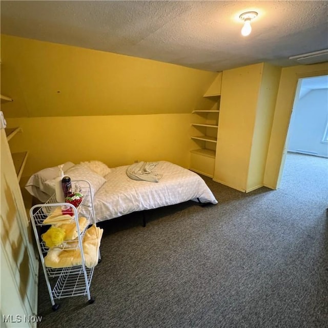 bedroom featuring lofted ceiling, carpet, and a textured ceiling