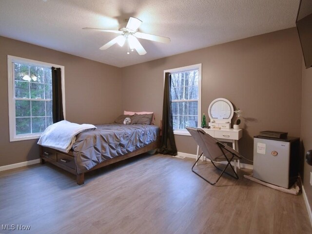 3945 Wheeler Creek Rd, Geneva, OH 44041 - bedroom with a textured ceiling, wood finished floors, baseboards, and a ceiling fan