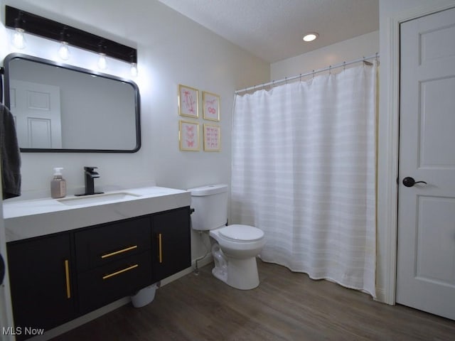 3945 Wheeler Creek Rd, Geneva, OH 44041 - bathroom featuring a textured ceiling, vanity, recessed lighting, toilet, and wood finished floors