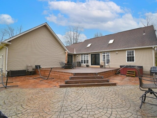 3945 Wheeler Creek Rd, Geneva, OH 44041 - rear view of property featuring roof with shingles, a wooden deck, and a hot tub