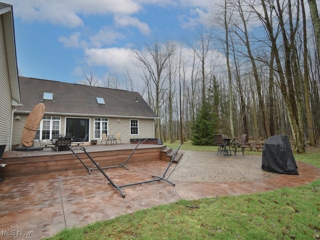 3945 Wheeler Creek Rd, Geneva, OH 44041 - rear view of property featuring a wooden deck, a patio, and roof with shingles