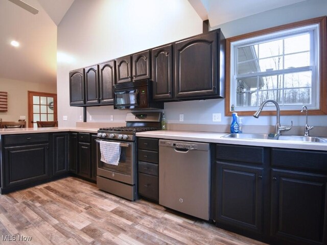 3945 Wheeler Creek Rd, Geneva, OH 44041 - kitchen featuring a sink, light countertops, lofted ceiling, and stainless steel appliances
