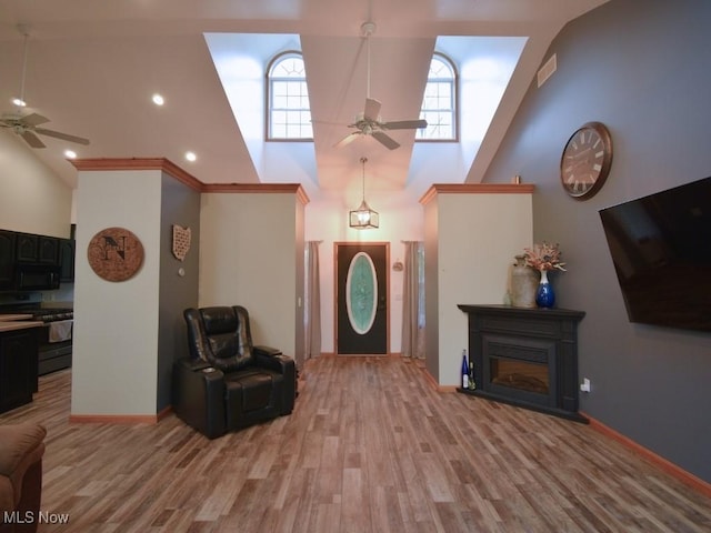 3945 Wheeler Creek Rd, Geneva, OH 44041 - living area with high vaulted ceiling, a wealth of natural light, light wood-style floors, and a ceiling fan