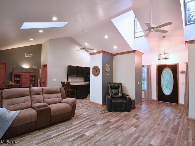 3945 Wheeler Creek Rd, Geneva, OH 44041 - living room featuring light wood-style floors, high vaulted ceiling, ceiling fan, visible vents, and a skylight
