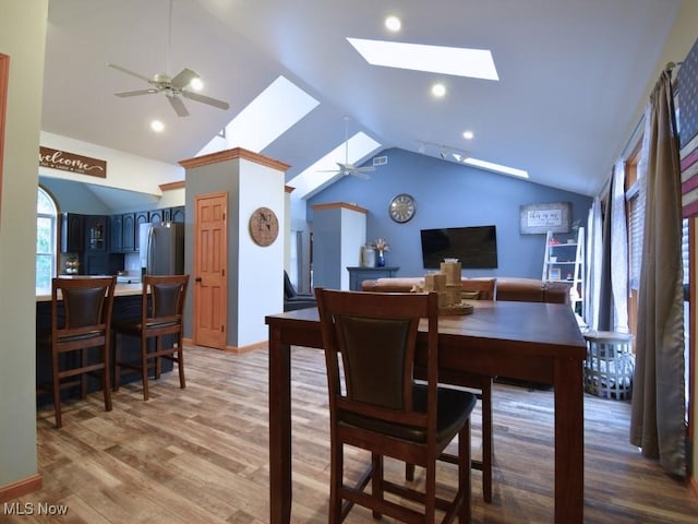 3945 Wheeler Creek Rd, Geneva, OH 44041 - dining area featuring recessed lighting, light wood-style flooring, ceiling fan, and lofted ceiling with skylight