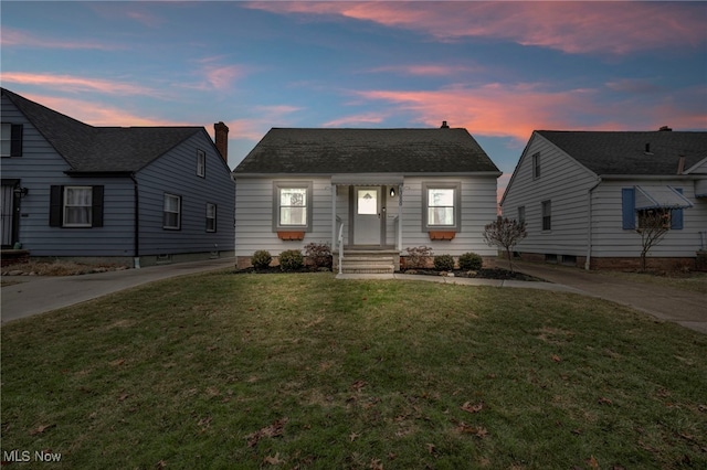 bungalow-style home featuring a front lawn