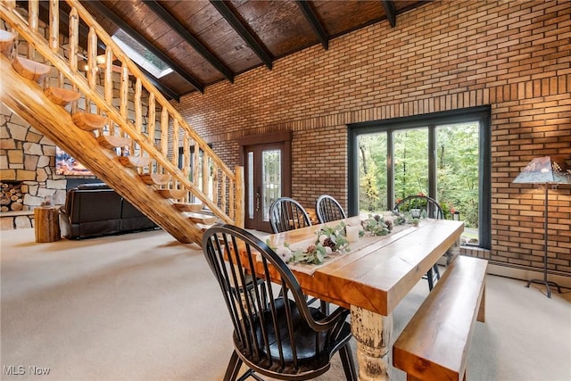 dining area featuring high vaulted ceiling, carpet, wood ceiling, and a healthy amount of sunlight