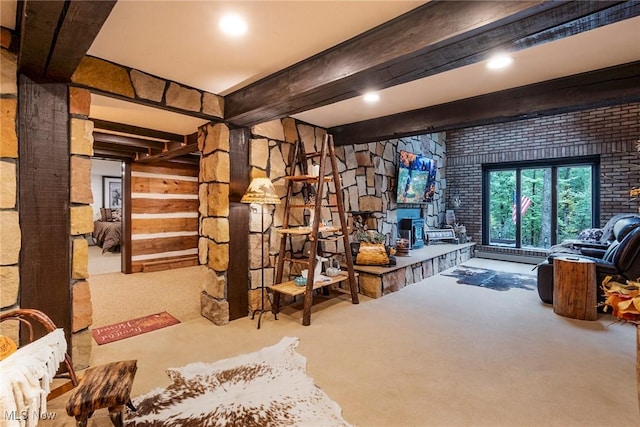 below grade area featuring carpet flooring and a fireplace with raised hearth