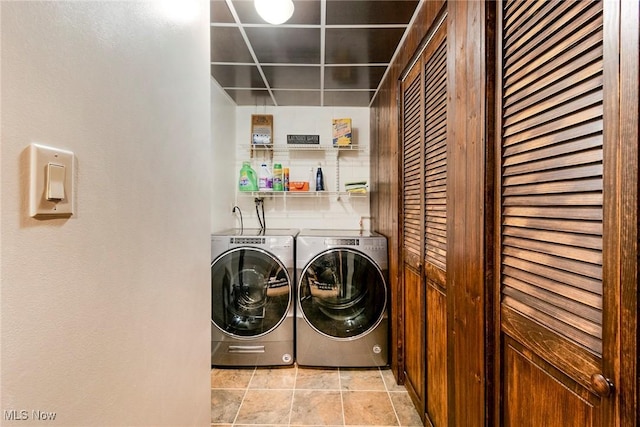 washroom with laundry area, light tile patterned floors, and separate washer and dryer