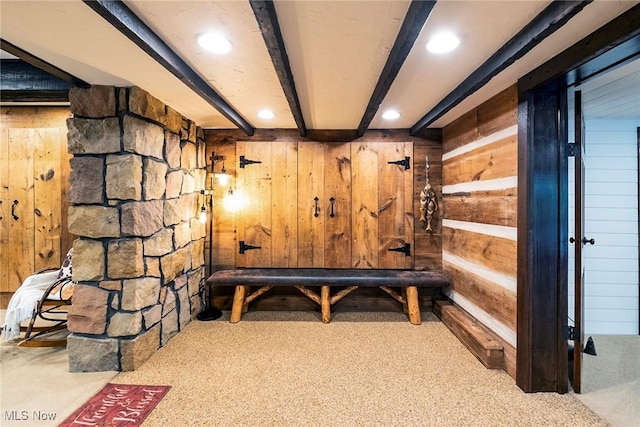 interior space with recessed lighting, carpet flooring, beam ceiling, and wooden walls