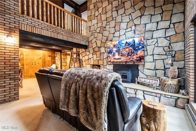 unfurnished living room featuring a high ceiling, baseboard heating, and carpet flooring