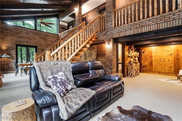 living room with a ceiling fan, carpet flooring, a towering ceiling, and stairs