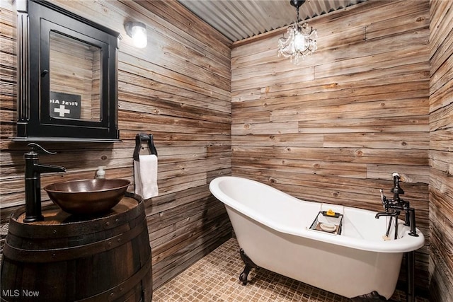 bathroom featuring a soaking tub, vanity, and tile patterned floors