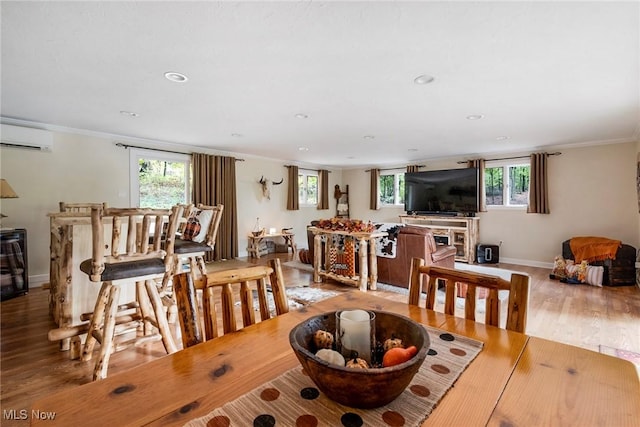 dining space featuring ornamental molding, plenty of natural light, and a wall mounted AC