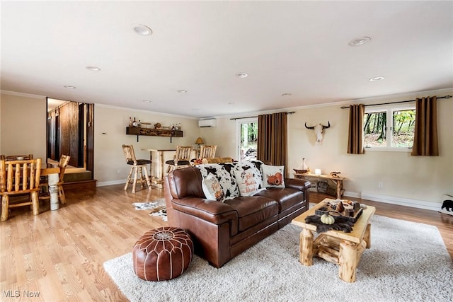 living area featuring recessed lighting, light wood-style flooring, a wall mounted AC, ornamental molding, and baseboards