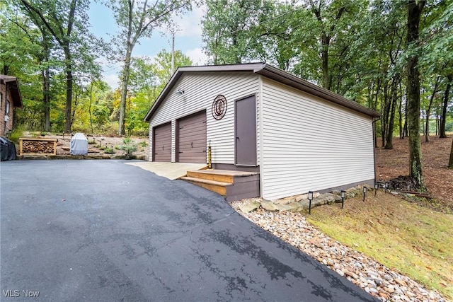 exterior space with an outbuilding and a detached garage