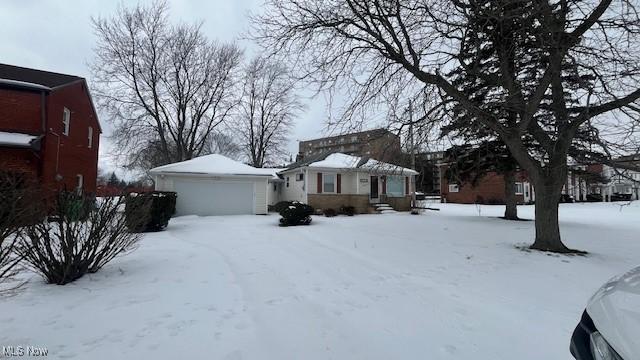 exterior space with an attached garage and an outdoor structure