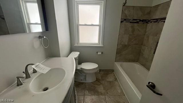 bathroom featuring toilet, plenty of natural light, tub / shower combination, and vanity