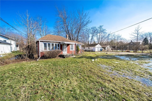 view of front of home featuring a front lawn and a chimney