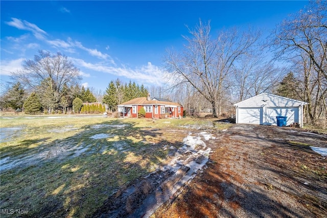 view of yard featuring an outbuilding and a detached garage