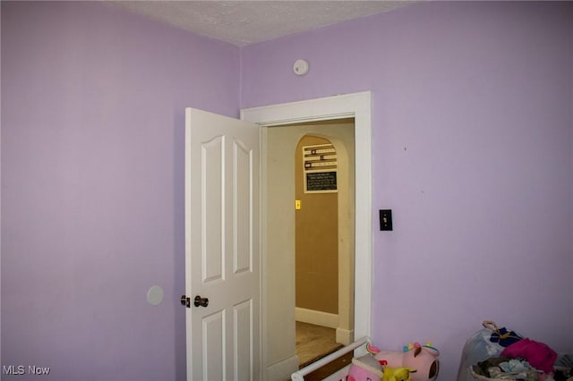 recreation room featuring a textured ceiling