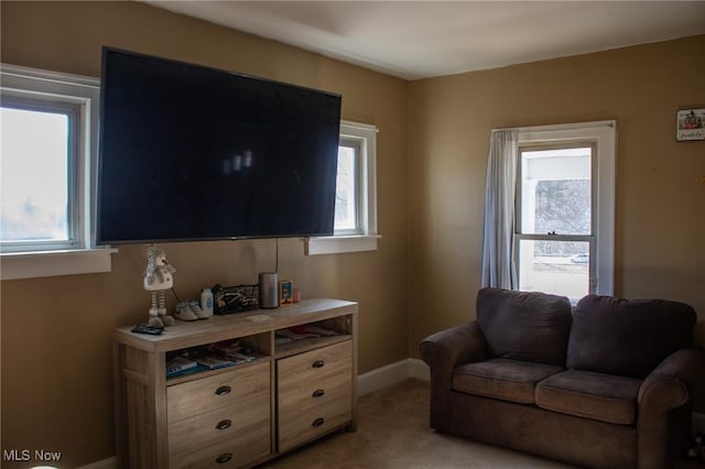 living room with light colored carpet and baseboards