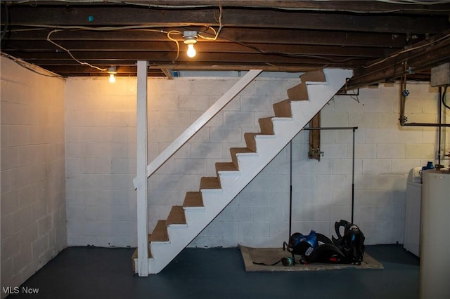 unfinished basement featuring stairway