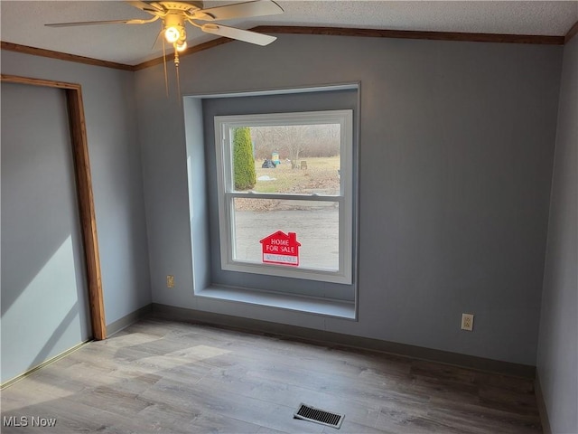 7443 Spillway Rd Lot 25, Lisbon, OH 44432 - empty room with baseboards, vaulted ceiling, visible vents, and light wood-style floors