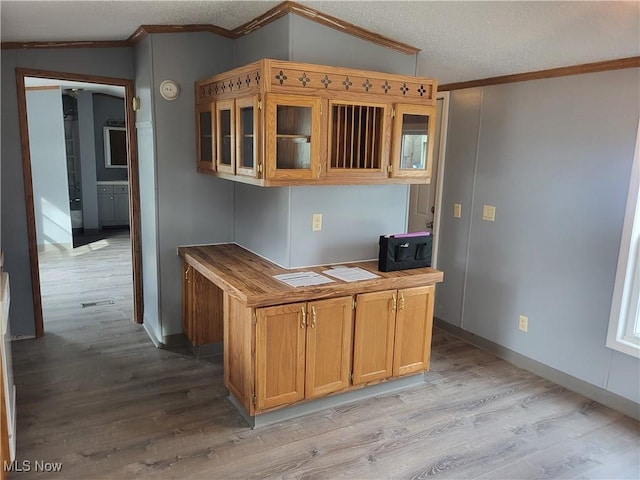 7443 Spillway Rd Lot 25, Lisbon, OH 44432 - kitchen with crown molding, glass insert cabinets, a textured ceiling, light wood-type flooring, and baseboards