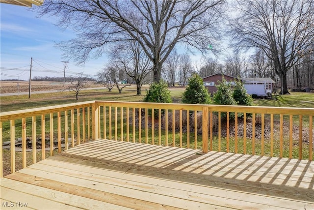 wooden terrace featuring a lawn