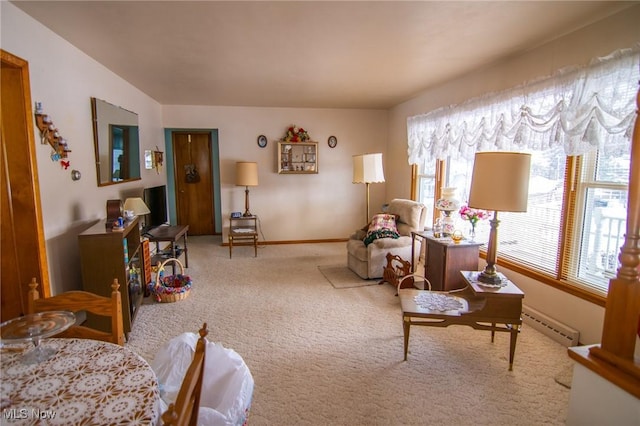 sitting room featuring a baseboard radiator, carpet flooring, and baseboards