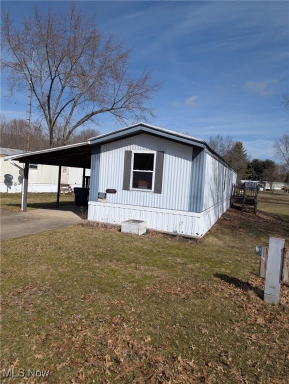 view of front of home with a front yard and an attached carport