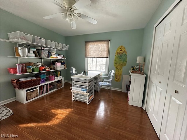 office space featuring ceiling fan, wood finished floors, and baseboards