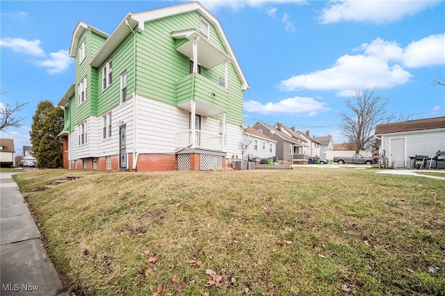 view of side of property with a yard and a residential view