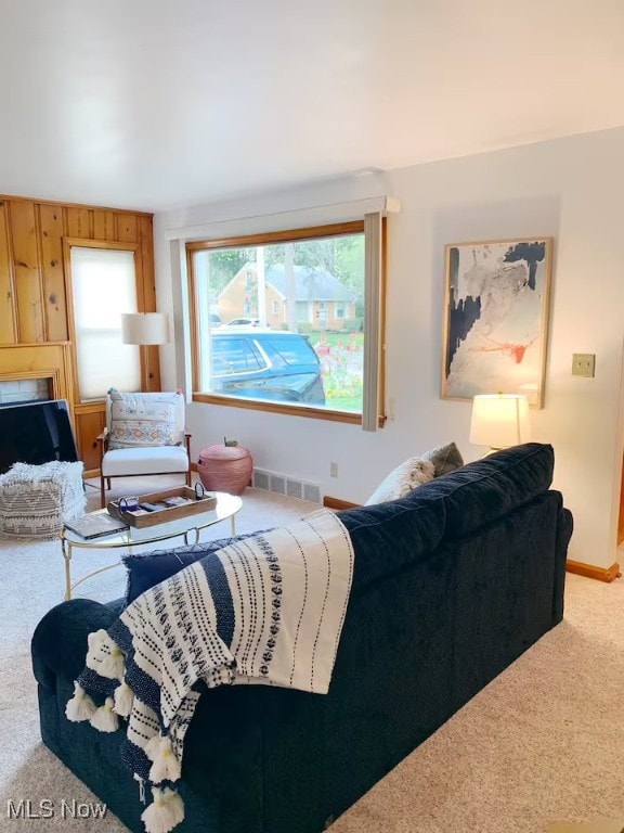 carpeted living room featuring baseboards and visible vents