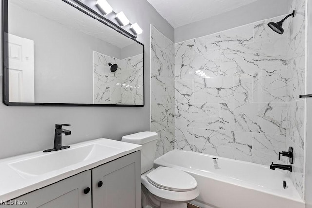 bathroom with shower / washtub combination, vanity, and toilet