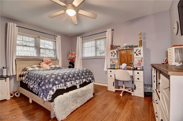 bedroom with baseboards, a ceiling fan, and wood finished floors