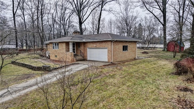 exterior space featuring driveway, a chimney, an attached garage, a front lawn, and brick siding