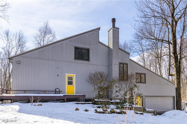 view of front of home with a garage and a chimney