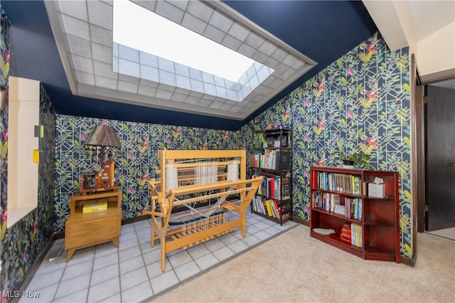 interior space with wallpapered walls, tile patterned flooring, and lofted ceiling with skylight