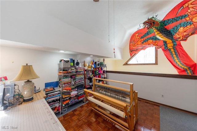 interior space featuring lofted ceiling and baseboards