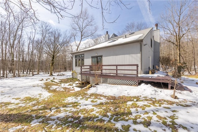 exterior space featuring a chimney and a wooden deck